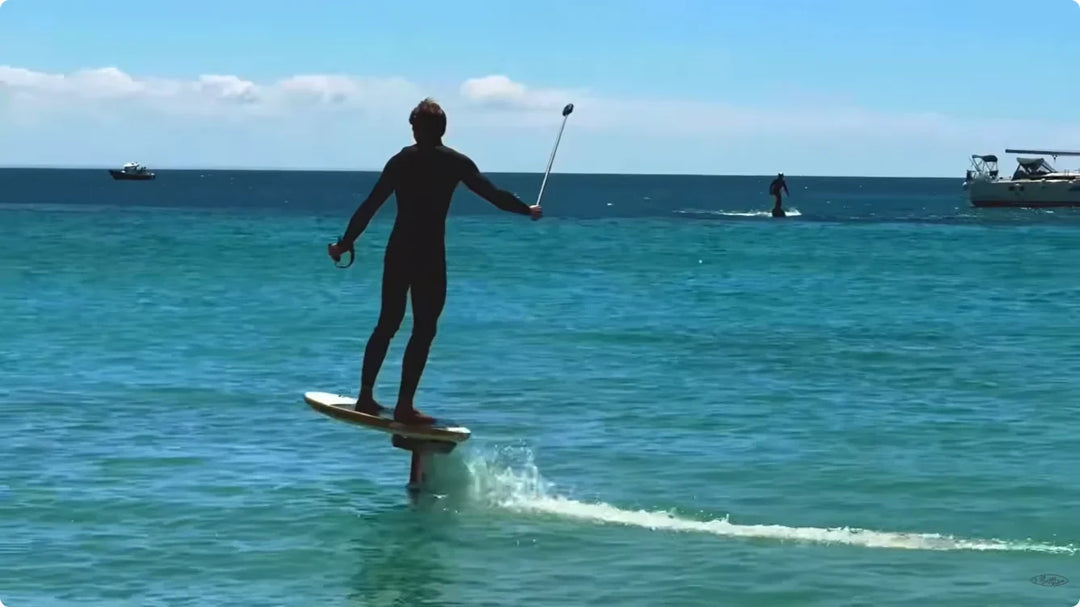 SUP foiler riding over clear water with Waydoo FoilBoost assistance